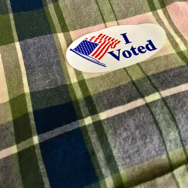 "I Voted" sticker on a plaid shirt