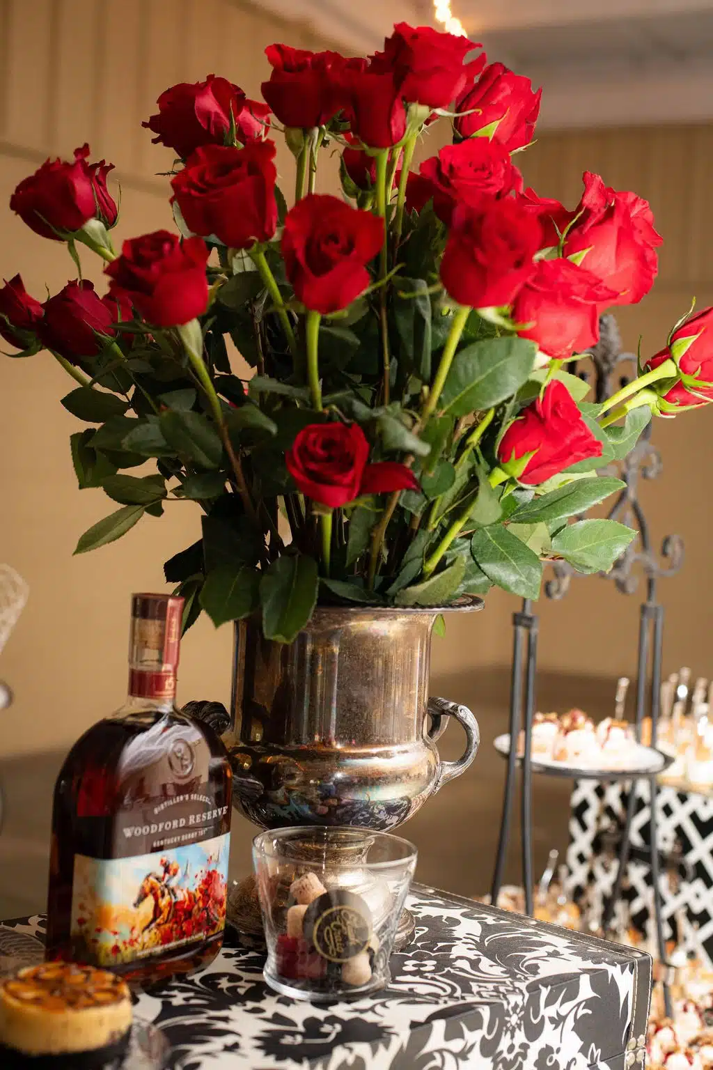 Arrangement of red roses with a Kentucky Derby edition bottle of bourbon